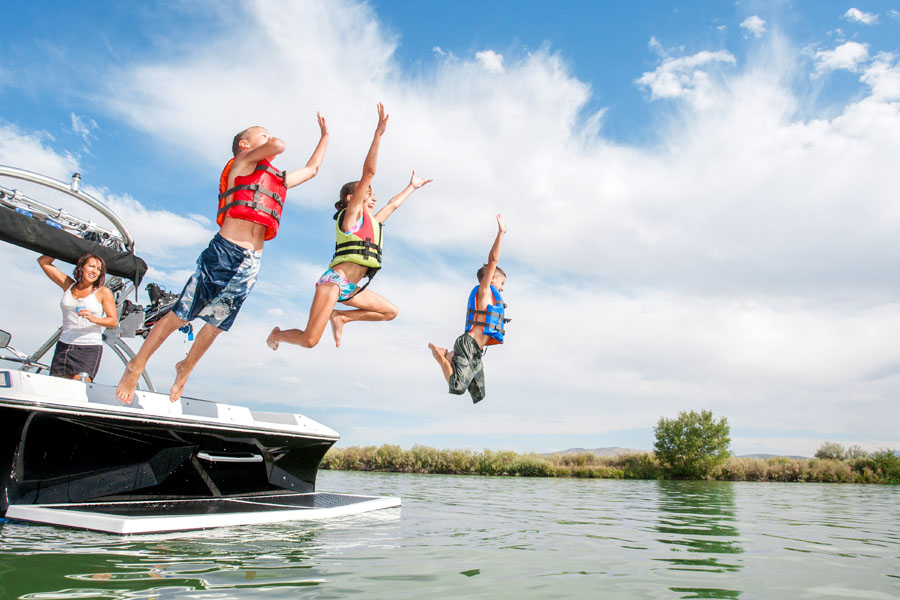Watercraft Insurance - Family Jumping Off Boat in the Lake